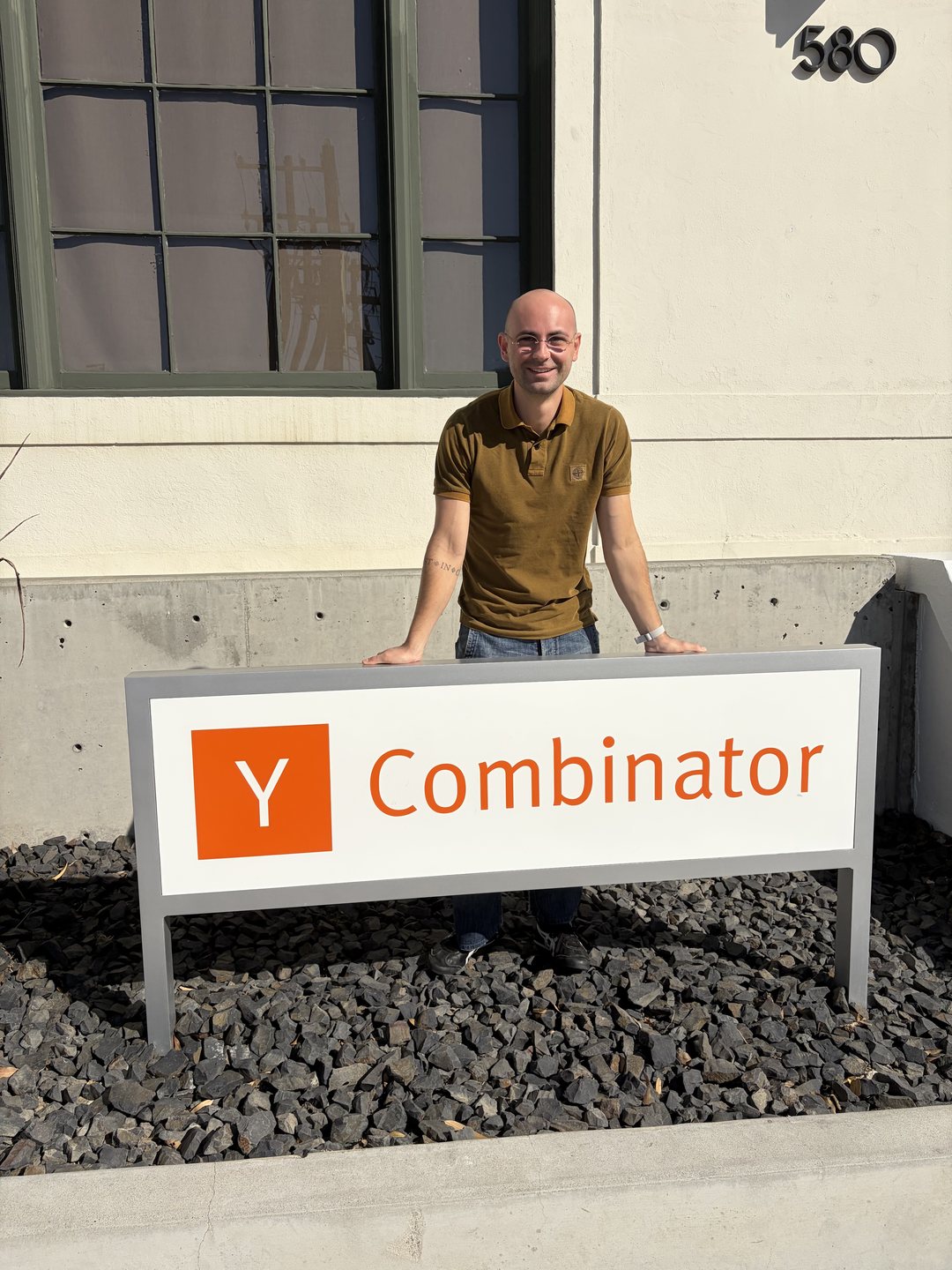 Enrico Milletti, founder of Silica, standing behind the Y Combinator sign